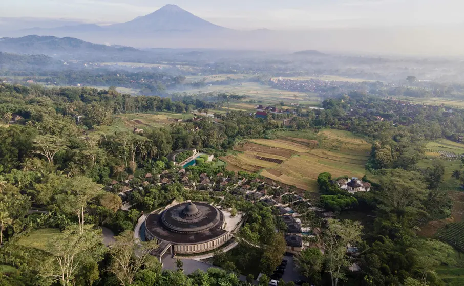 An estate seen from above, set among rice terraces and forest