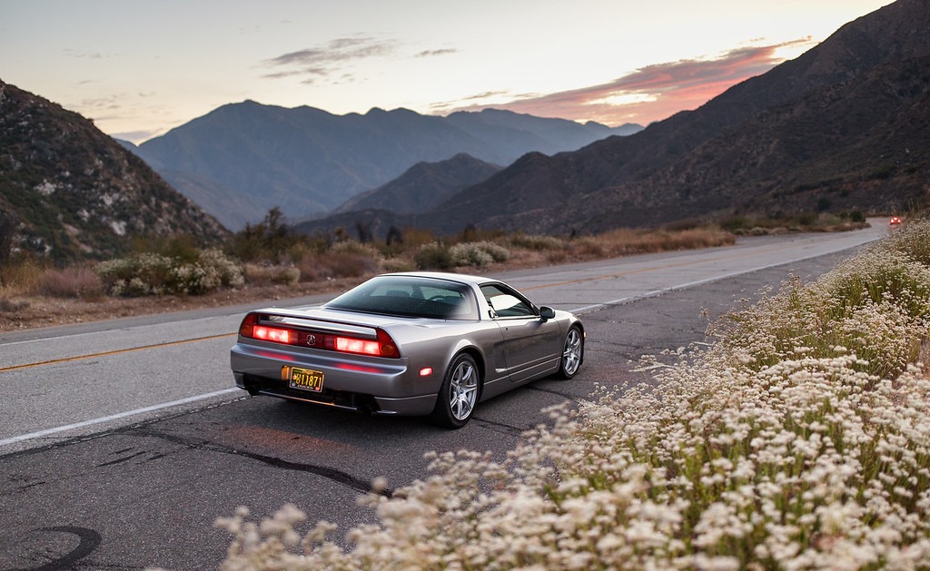 A car on a mountain road at dusk