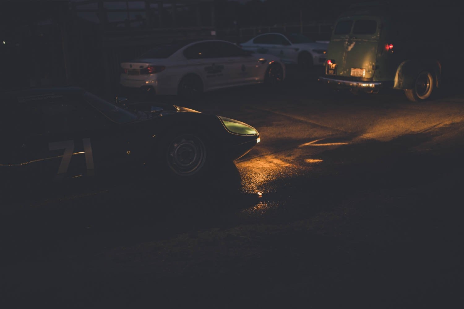 Cars parked in a paddock at dusk
