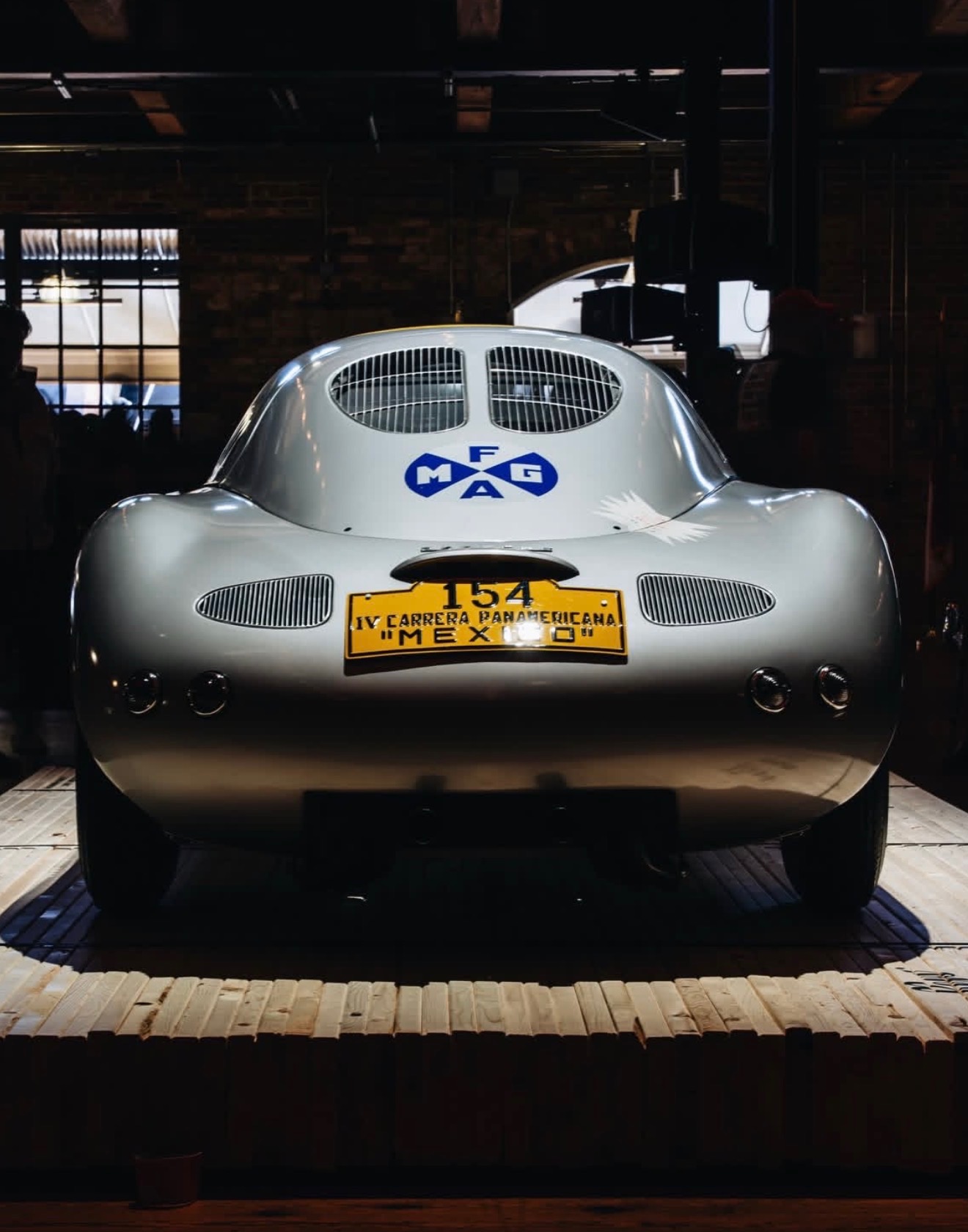A vintage Porsche on display in a workshop